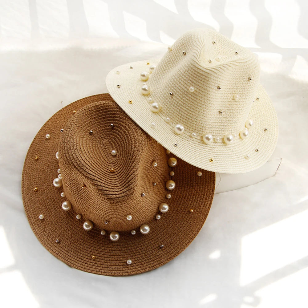 Elegant straw hat with pearl trim on display stand against neutral background