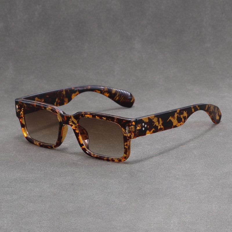 Tortoiseshell sunglasses on a gray background