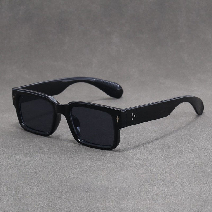 Black sunglasses on a gray background