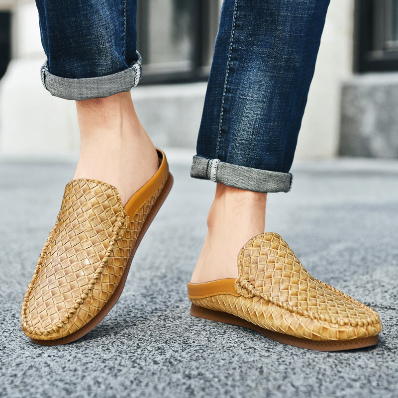 Person wearing woven brown slippers on a concrete surface