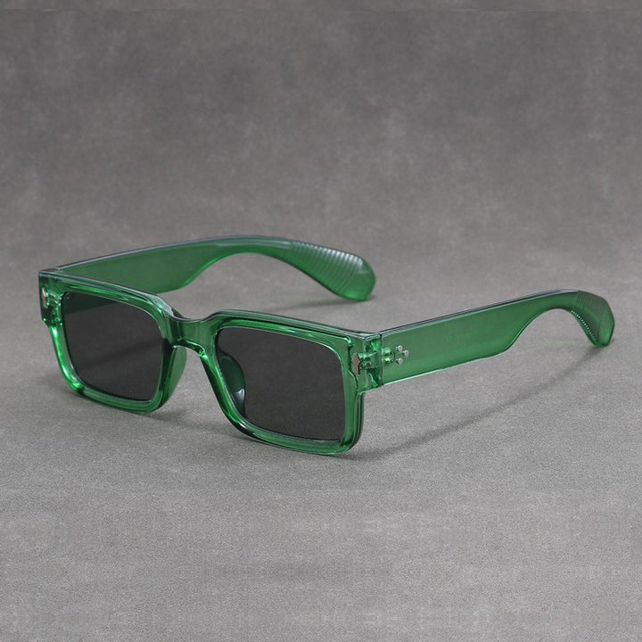 Green sunglasses with black lenses on a gray background