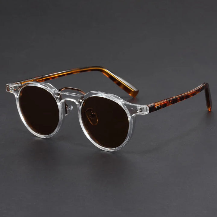 A pair of round-framed sunglasses with clear browline design and brown tortoiseshell patterned temples.