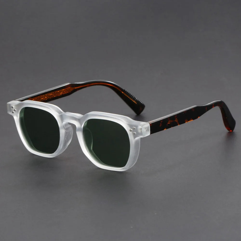 A pair of square-framed sunglasses with studded temples, featuring a patterned frame design and tinted lenses.