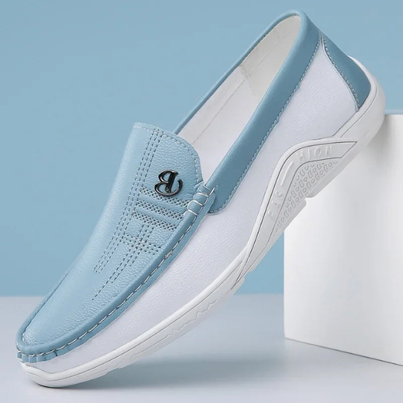 Light blue loafers with a white sole on a light blue background
