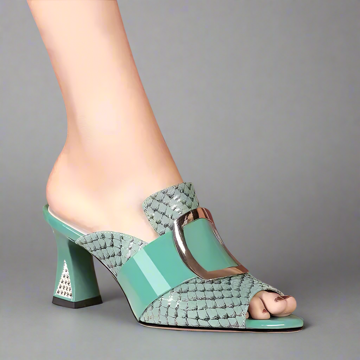 Teal high-heeled shoes with woven design on a neutral background