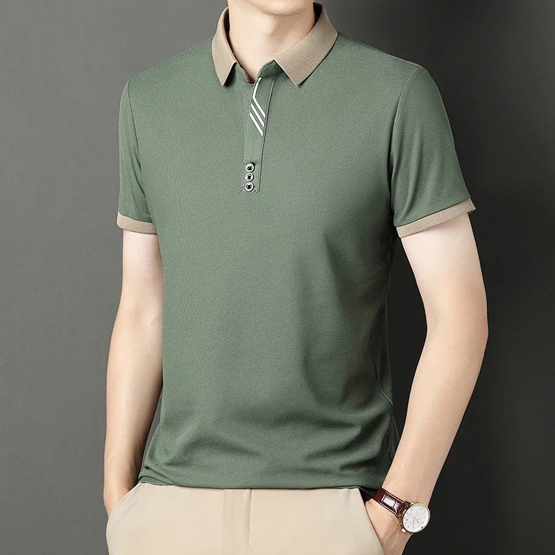 Green polo shirt with beige collar and trim worn by a person on a dark background