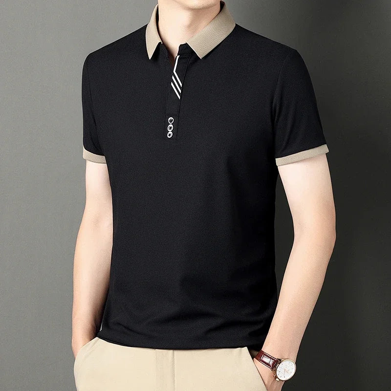 Black polo shirt with beige collar and trim on a gray background