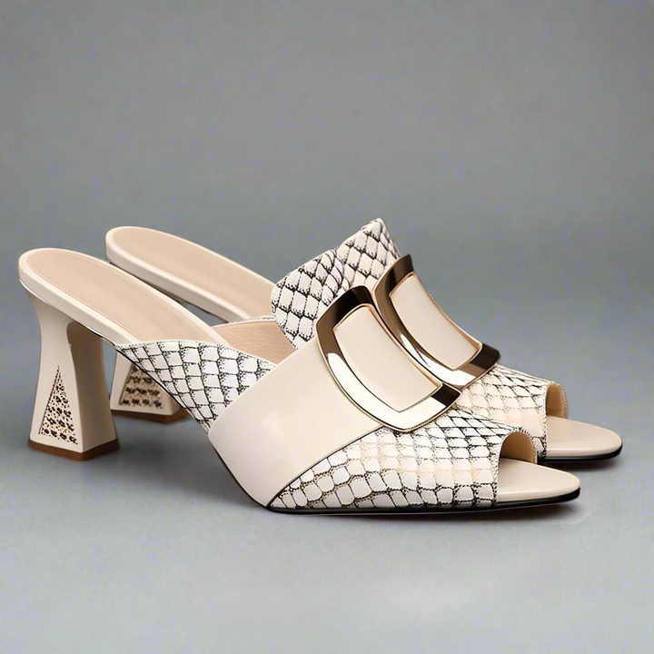 Pair of high-heeled shoes with snake print and gold buckle on a black background