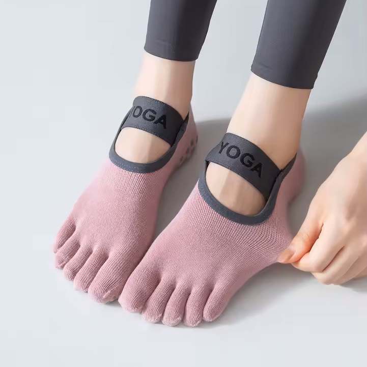 Yoga socks with toe separation and 'Yoga' label on a light gray background